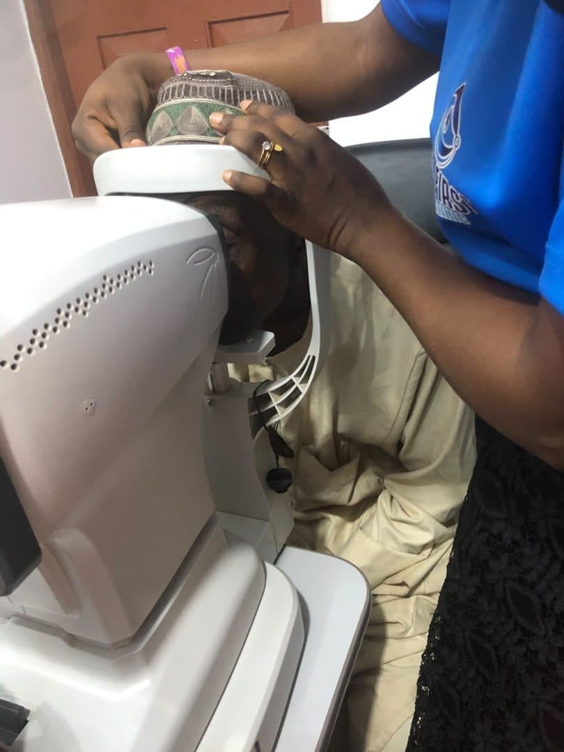 Close-up of a God First clinician performing a diagnostic eye examination
