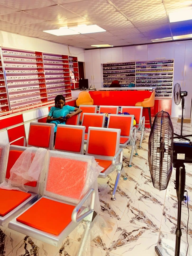 The God First optical showroom with a wide selection of frames on display and a comfortable waiting area